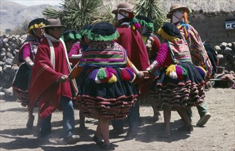 Peru, Cusco, Vilcanota Mountains, Tinqui. Villagers in traditional costume dancing during wedding