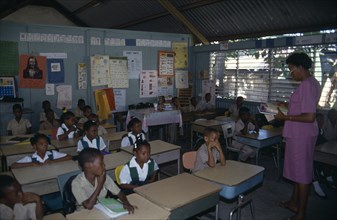West Indies, Jamaica, Falmouth, First Grade pupils in classroom with female teacher. Photo : Nancy