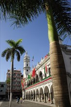 Mexico, Veracruz, Palm trees in the zocalo and government buildings decorated with national colours