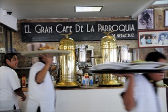 Mexico, Veracruz, Cafe El Gran Cafe de la Parroquia interior with waiters carrying laden trays past