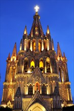 Mexico, Bajio, San Miguel de Allende, La Parroquia church neo-gothic exterior illuminated at night.