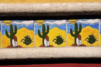 Mexico, Bajio, San Miguel de Allende, Detail of colourful tile depicting figure in Mexican hat