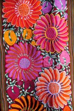 Mexico, Bajio, San Miguel de Allende, Detail of brightly coloured embroidered textile in arts shop
