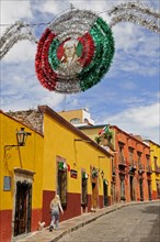 Mexico, Bajio, San Miguel de Allende, Independence Day decorations adorn colonial street lined by