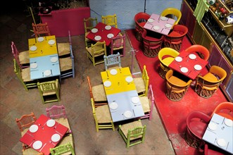 Mexico, Bajio, Queretaro, Elevated view looking down on tables in colourful restaurant interior.