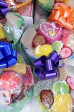 Mexico, Puebla, Colourful sweets wrapped and tied with brightly coloured ribbon. Photo : Nick