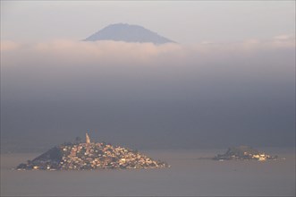 Mexico, Michoacan, Patzcuaro, Early morning misty view of Lago Patzcuaro with Isla Janitzio. Photo