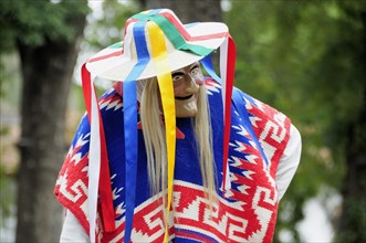 Mexico, Michoacan, Patzcuaro, Dancer in mask and costume performing Danza de los Viejitos or Dance