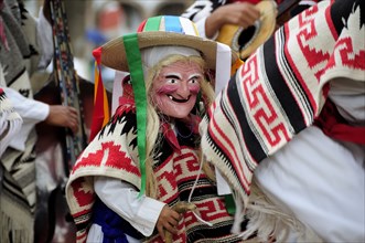 Mexico, Michoacan, Patzcuaro, Child wearing mask and costume for Danza de los Viejitos or Dance of