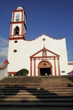 Mexico, Veracruz, Papantla, Cathedral de la Asuncion white and red painted exterior facade and bell