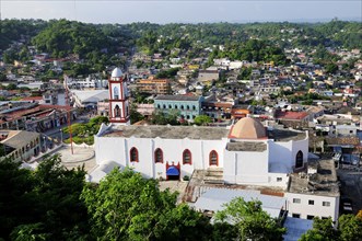 Mexico, Veracruz, Papantla, Views over Cathedral Zocalo and surrounding buildings set amongst trees