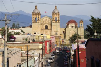 Mexico, Oaxaca, View towards church of Santo Domingo over street and rooftops of surrounding