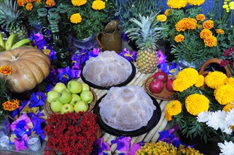 Mexico, Michoacan, Patzcuaro, Altar with display of food and flowers including marigolds for Dia de
