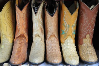 Mexico, Jalisco, Guadalajara, Line of embroidered leather boots for sale. Photo : Nick Bonetti