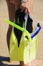 Mexico, Oaxaca, Huatulco, Playa La Entrega Cropped shot of woman snorkler carrying mask and
