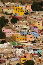Mexico, Bajio, Guanajuato, Elevated view across brightly painted housing with flat rooftops. Photo