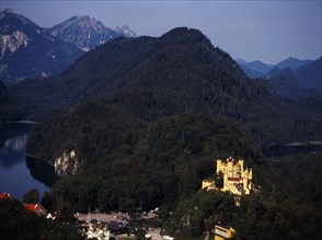 Germany, Bayern, Schwangau, View looking down on town overlooked by Schloss Hohenschwangau and