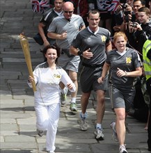 England, Kent, Tunbridge Wells, Olympic Torch relay running through the Pantiles. Photo : Sean
