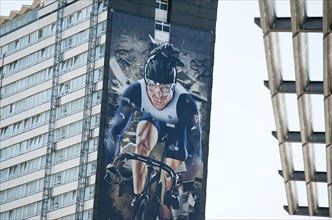 Giant mural of UK cyclist, Sir Chris Hoy covers the side of a block of flats