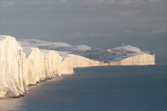 England, East Sussex, Seven Sisters, Snow covered coastline from Birling gap showing the coastguard