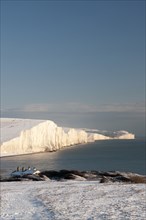 England, East Sussex, Seven Sisters, Snow covered coastline from Birling gap showing the Coastguard