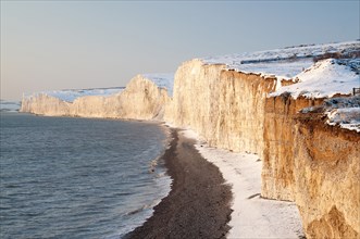 England, East Sussex, Seven Sisters, Snow covered chalk cliffs looking west towards Cuckmere haven