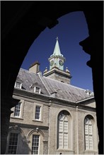 Ireland, County Dublin, Dublin City, Kilmainham Royal Hospital clock tower viewed through an arch