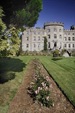 Ireland, County Sligo, Markree, Castle hotel view of a section of the castle with row of flowers in