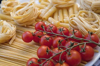 Italy, Lazio, Rome, Food Italian Dried pasta and tomatoes on the vine. Photo : Bennett Dean