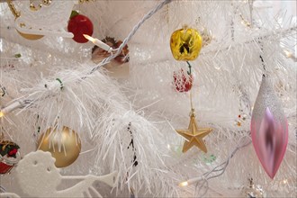 Festivals, Religious, Christmas, Detail of tree decorated with lights tinsel and various baubles.