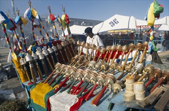 Tibet, Lhasa, Barhor Square, Display of Prayer wheels and flags for sale at a market. 
Photo