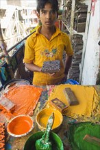 Bangladesh, Dhaka, Young man holding a printing block used to print on cotton fabrics in New Market