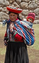 Peru, Indigenous People, Woman with baby in traditional dress. 
Photo Richard Rickard / Eye