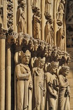 France, Ile de France, Paris, Notre Dame cathedral detail of carvings around the entrance. 
Photo