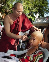 Thailand, Chiang Mai, Shaving of hair is part of the ritual of Poi Sang Long. This is the