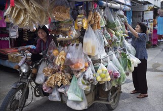 Thailand, Chiang Mai, San Kamphaeng mobile market on a motorcycle. 
Photo Martin F. Johnston / Eye