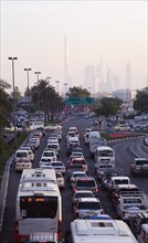 UAE, Dubai, Traffic in Deira during rush hour with skyline showing Burj Khalifa tower. 
Photo John