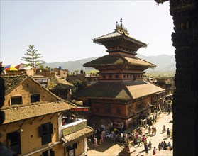 Nepal, Bhaktapur, Taumadhi Square View through pillars of temple of goddess Siddhi Laxmi. 
Photo