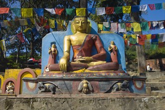 Nepal, Kathmandu, Buddha statue at the foot of the Swayambunath Monkey Temple. 
Photo Nic I Anson