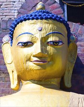 Nepal, Kathmandu, Beautiful golden Buddha head statue at theSwayambunath Monkey Temple. 
Photo Nic