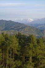 Nepal, Nagarkot, View across clouded Kathmandu valley towards Himalayan mountains. 
Photo Nic I