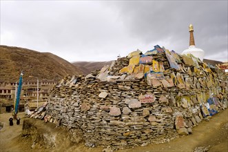 China, Szechuan Province, Tibet, Litang county Mani stone wall outside Litang Buddhist Monastery in