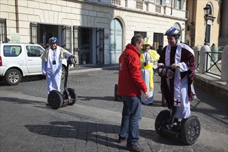 Italy, Lazio, Rome, Tourists dressed as Bishops to take tour on Segways. 
Photo Stephen Rafferty /