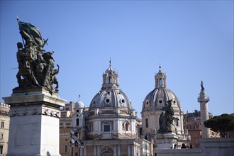 Italy, Lazio, Rome, Statue outside the Victor Emmanuel II monument with Church domes in the