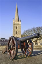 Ireland, North, Derry, St Columb's Cathedral with cannon on city walls in the foreground. 
Photo