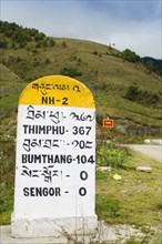 Bhutan, Sengor, Milestones on the side of the main east-west highway showing distances to towns.