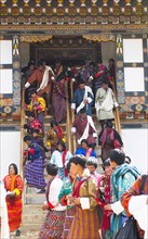 Bhutan, Gangtey Gompa, Tsecchu festival crowds descending temple steps dressed in their best