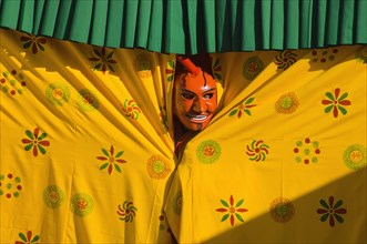 Bhutan, Thimpu Dzong, Atsara, or comedian peering out from behind a curtain at a masked dance