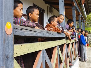 Bhutan, Mongar, Schoolchildren standing outside class. 
Photo Nic I'Anson
