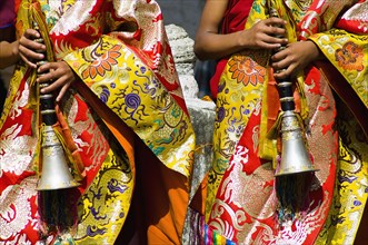 Bhutan, Bumthang District, Tamshing Lhakang, Buddhist pipe players dressed in ceremonial silk robes